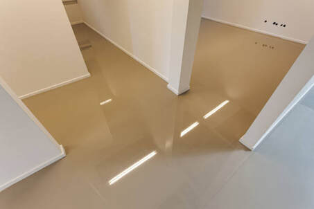 Completed epoxy flooring installation  being installed in a basement in Norwalk, CT.