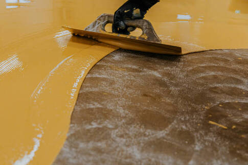 Yellow epoxy being installed with a trough.