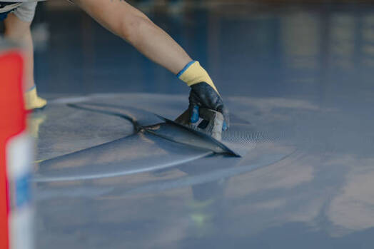 Man installing epoxy flooring in Norwalk, CT.