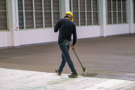 Person installing epoxy flooring.